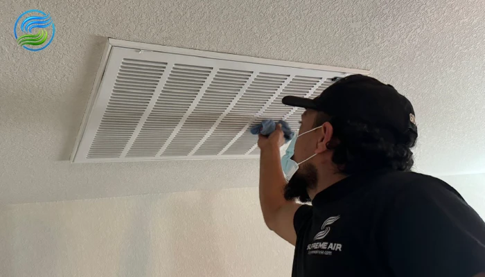 technician inspecting the air duct vent
